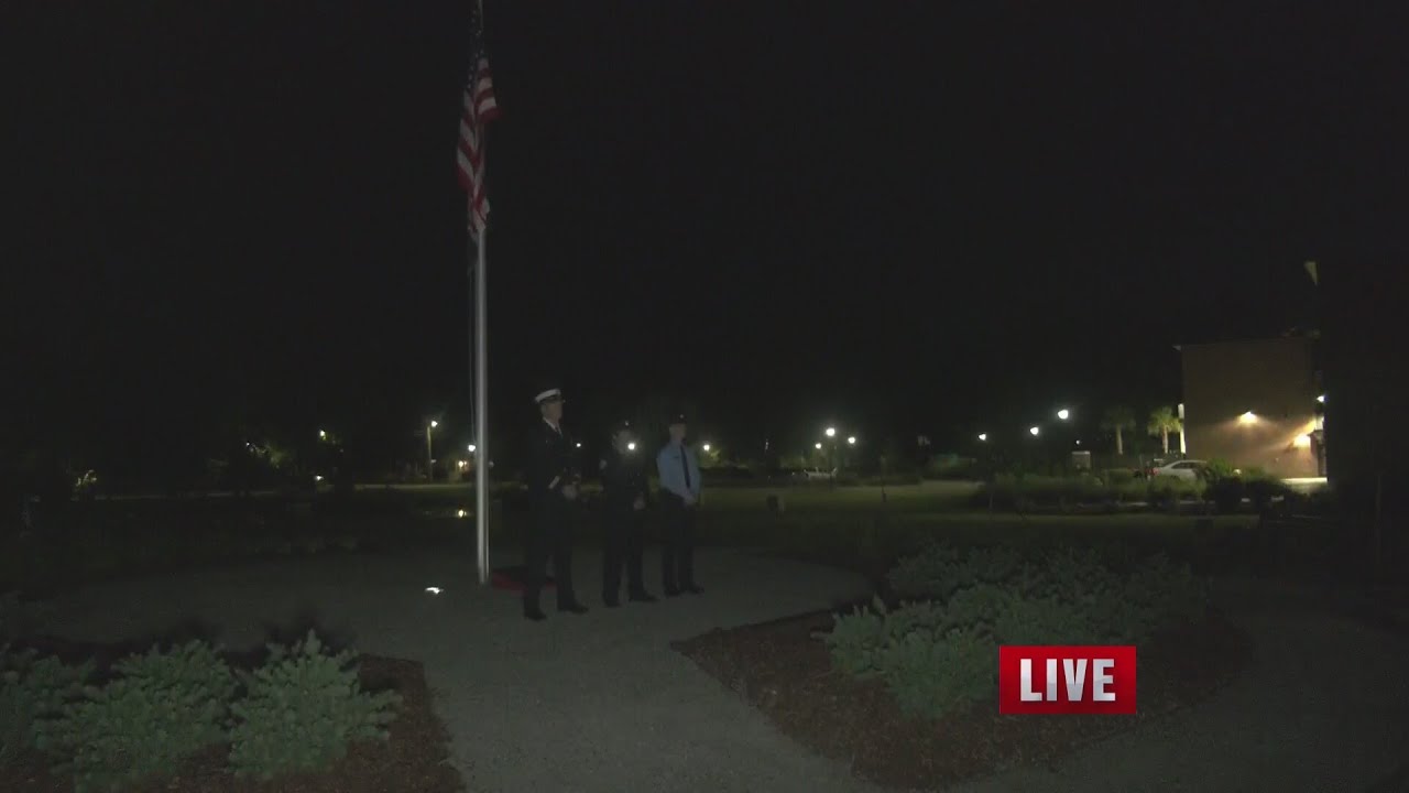 Firefighters stand watch at Charleston 9 Memorial Park