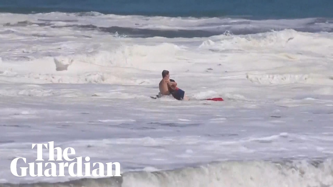 Teen lifeguard struggles to drag boy out of massive waves in California