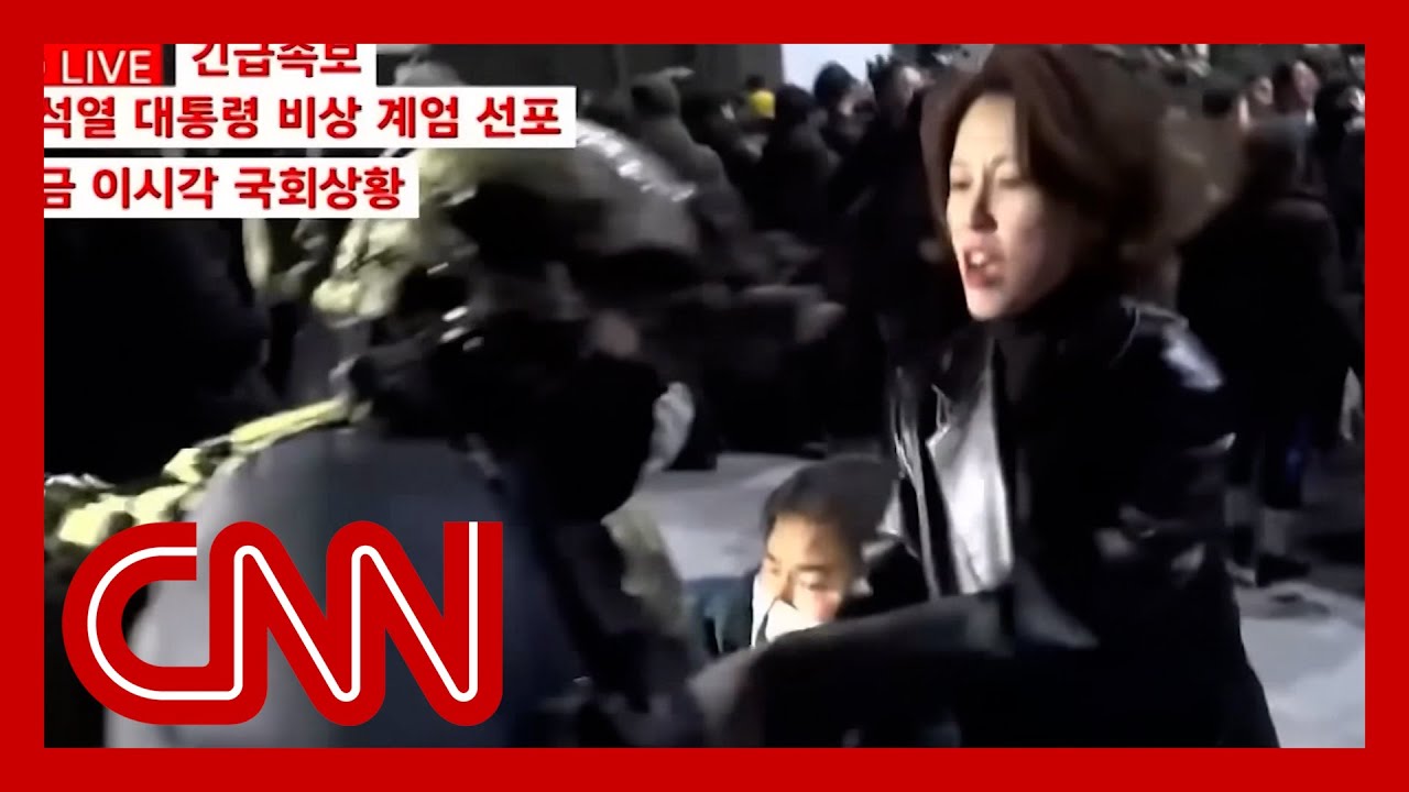 Soldier points rifle at lawmaker outside South Korean parliament