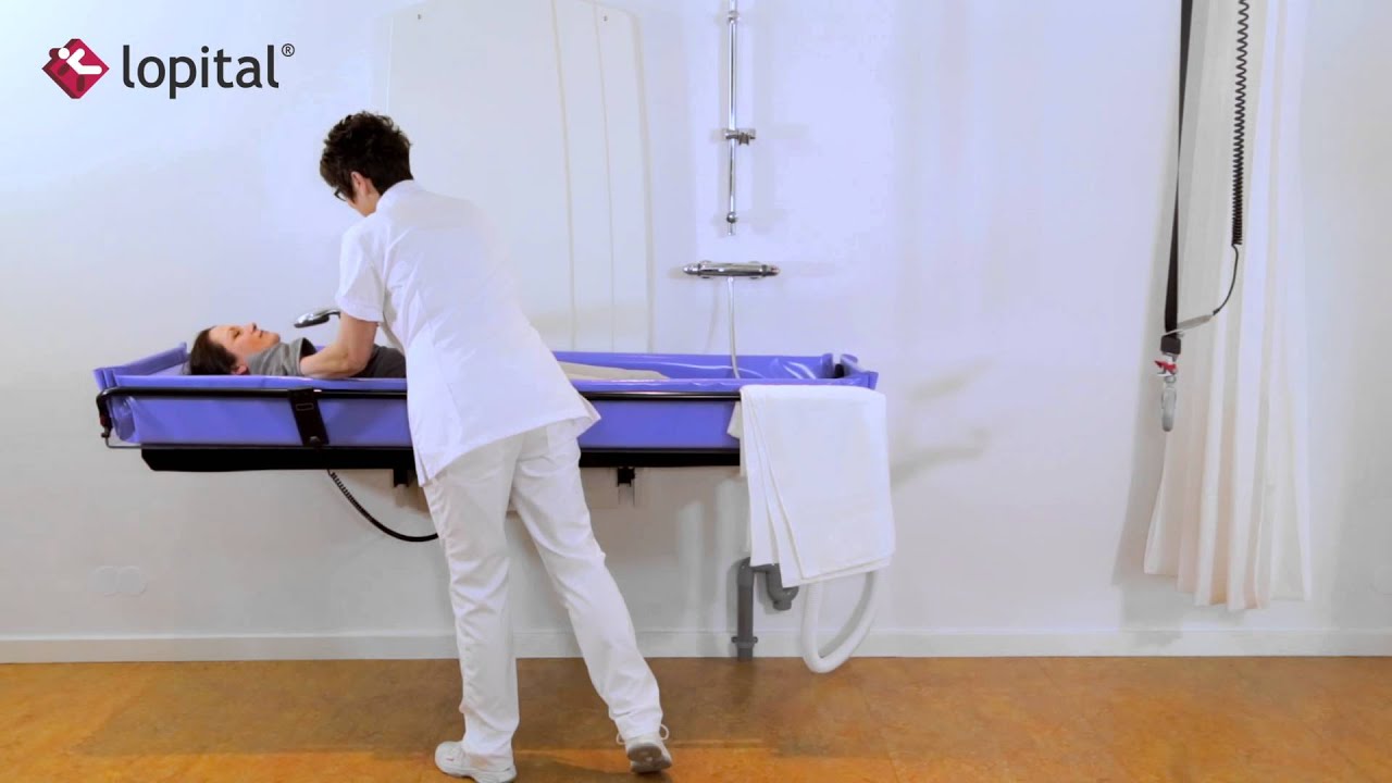 Lopital - Lehrvideo - Sirocco Elektrisch h&ouml;henverstellbar Wand Duschliege (DE)
