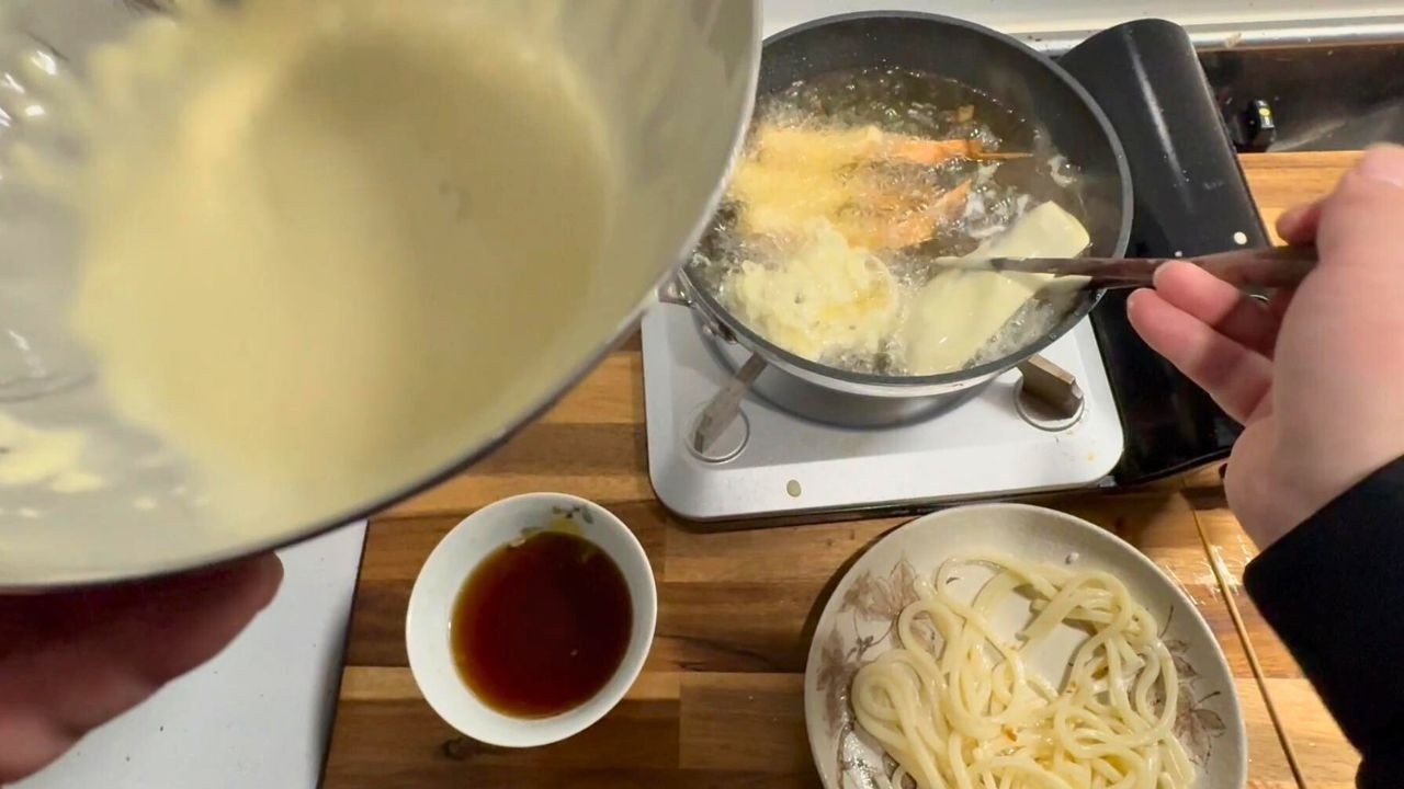 Japanese salarymen eat freshly fried tempura for dinner.