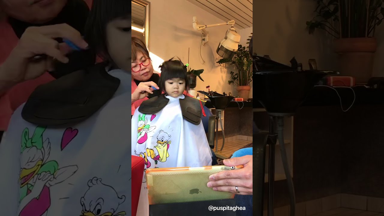 Kuhn Ya (Grandma) cutting Ross hair