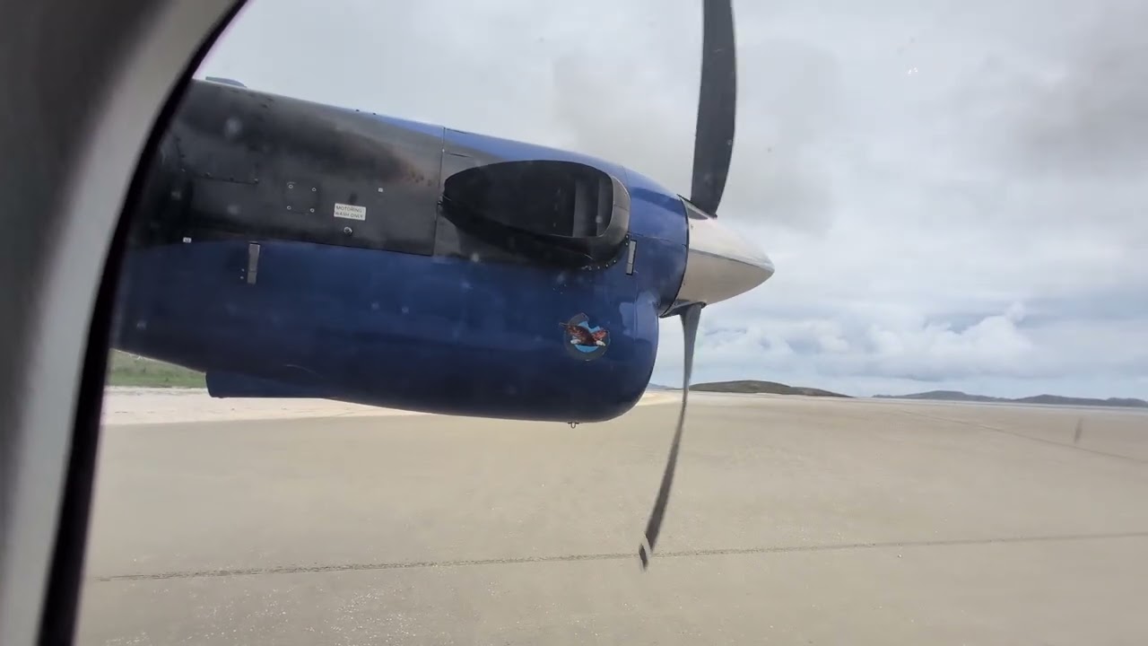 Loganair Viking Twin Otter departure from the Beach at Isle of Barra in the Scottish Hebrides 