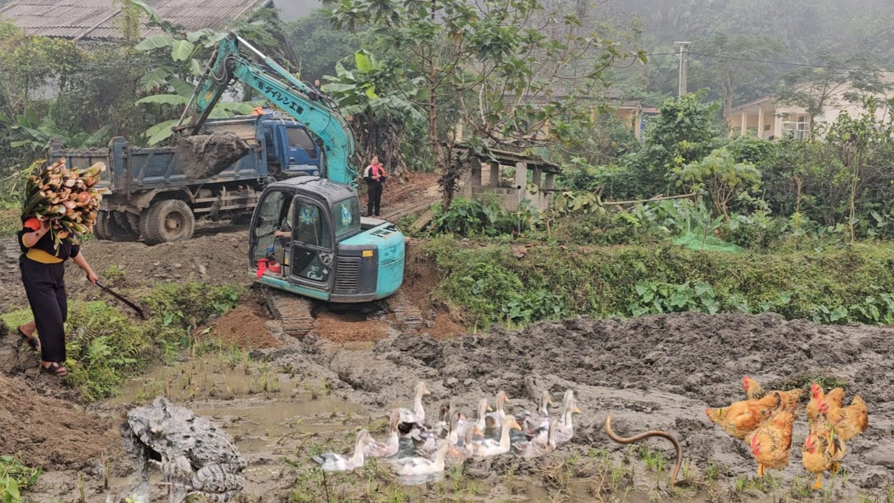 Excavators and trucks complete which task to dredge the deepest mud in Southeast Asia
