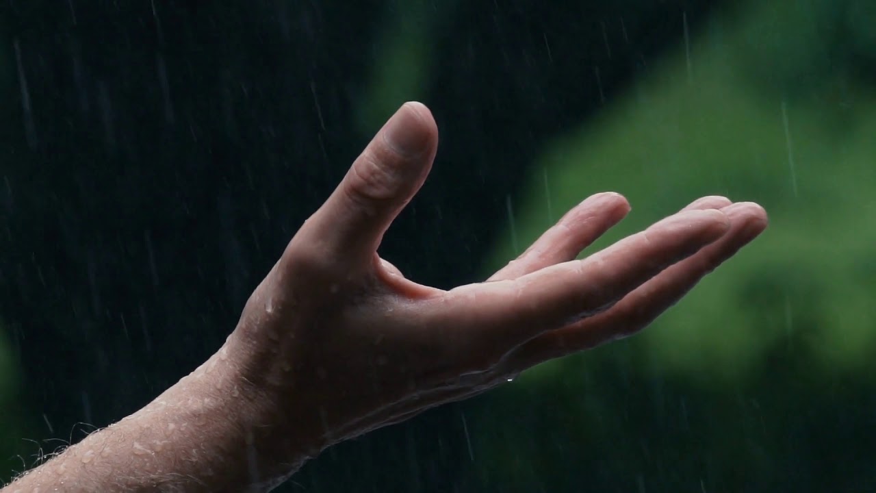 Rain falling on hand in slow motion - no Copyright
