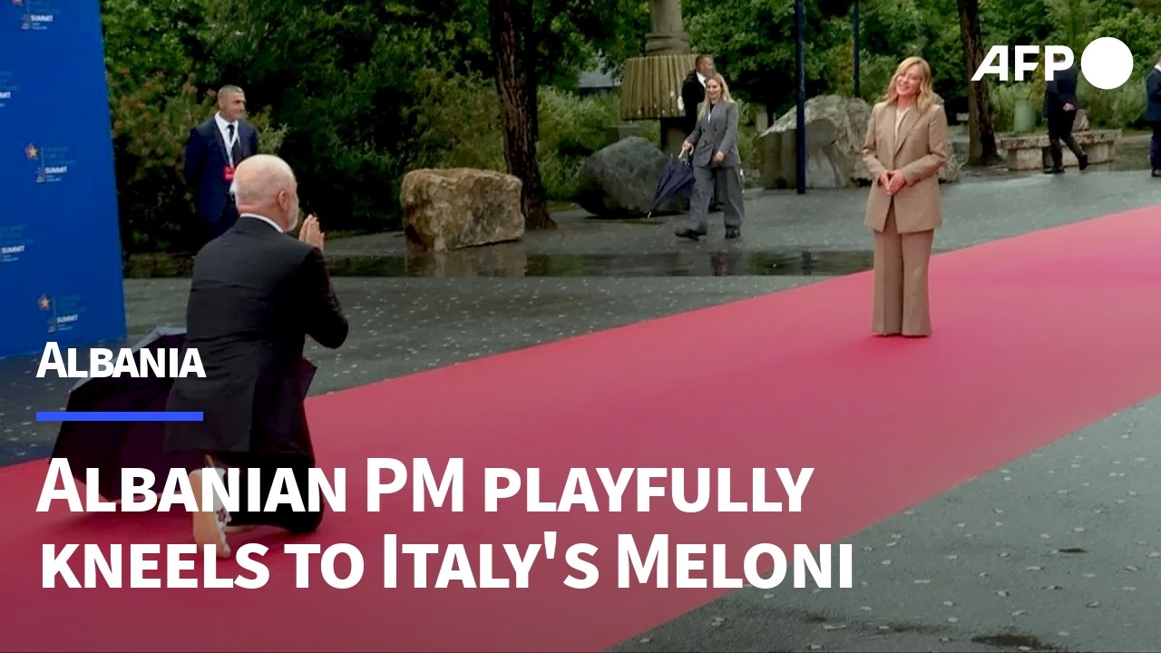 Albanian PM Rama kneels playfully to greet Italy's Giorgia Meloni | AFP