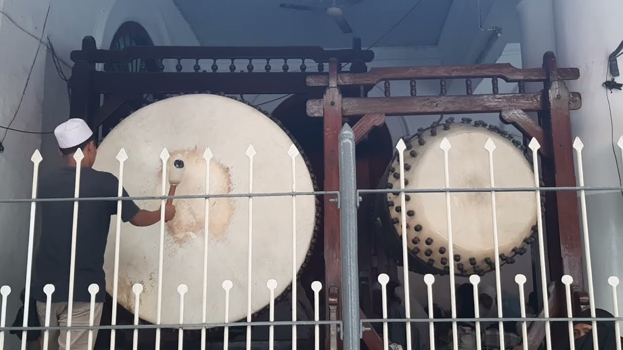 Traditional muslim call to prayer using bedug (huge drum from leather) in Indonesia