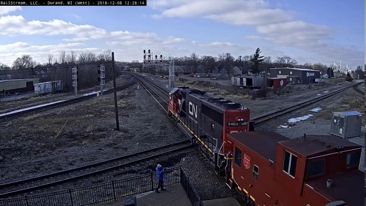 Caboose sandwiched by CN SD60 And SD75 at Durand, MI. (Railstream)