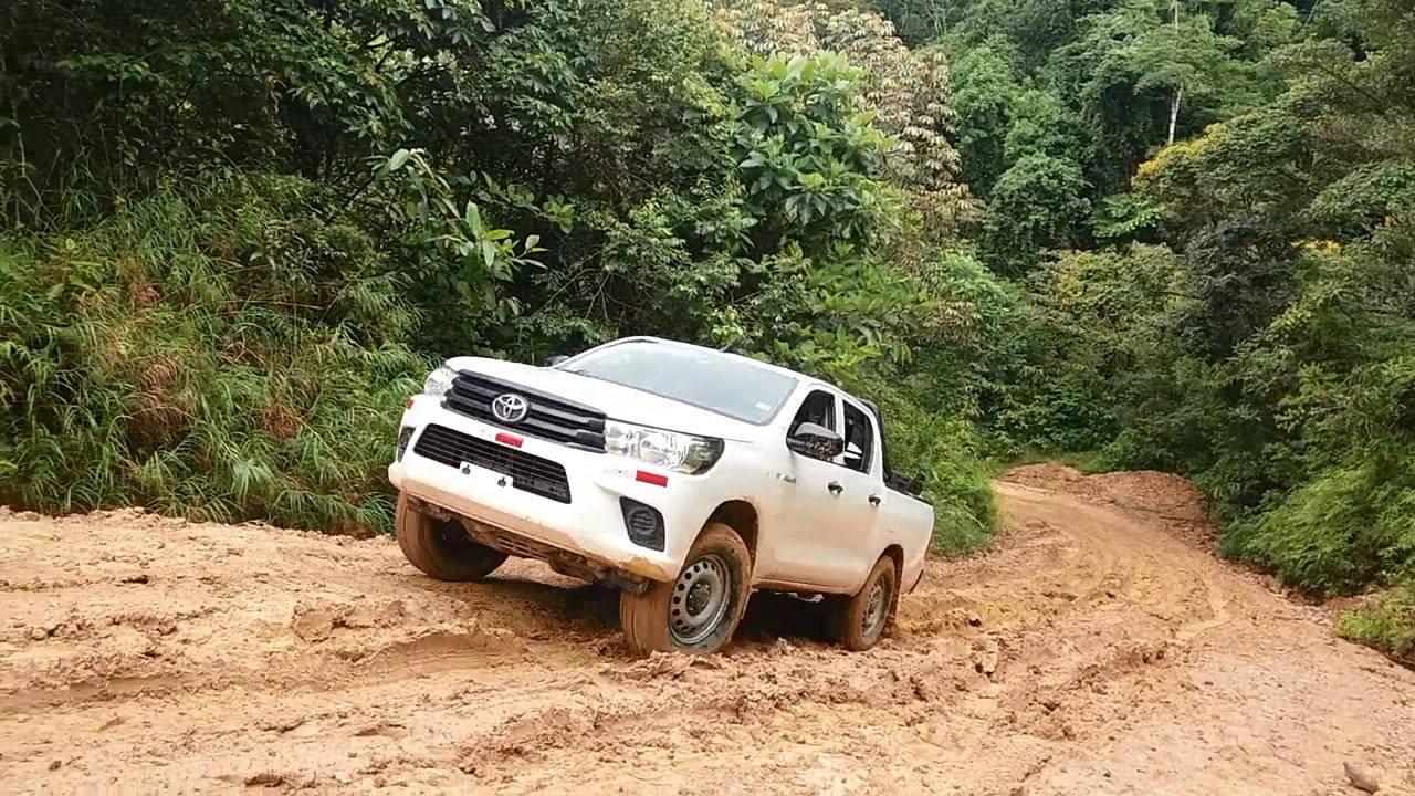 Toyota Hilux and Nissan Frontier On Muddy Climbing Routes - Pickup Truck On Mud Climb Track