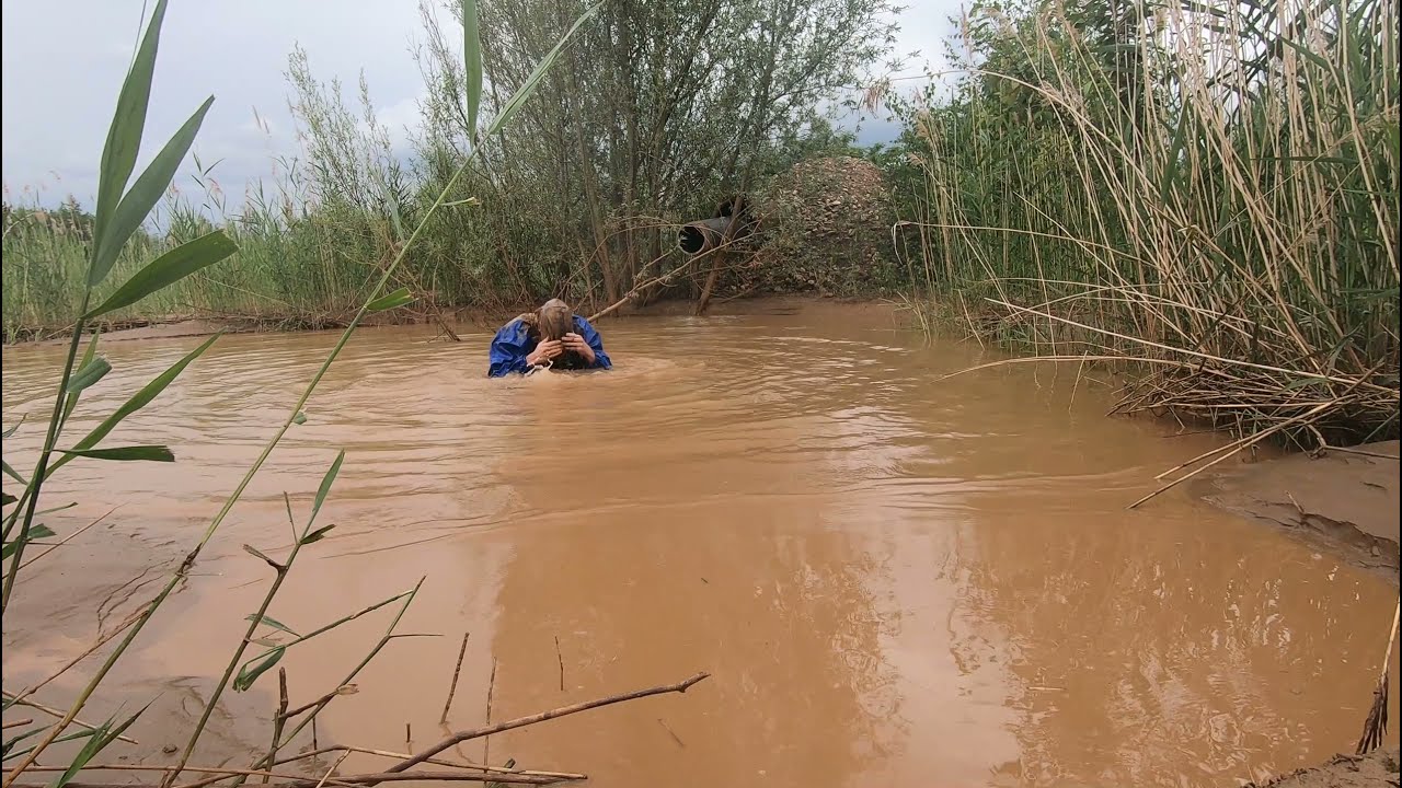 Jeans, rainwear and rubberboots in deep quarry mud 5