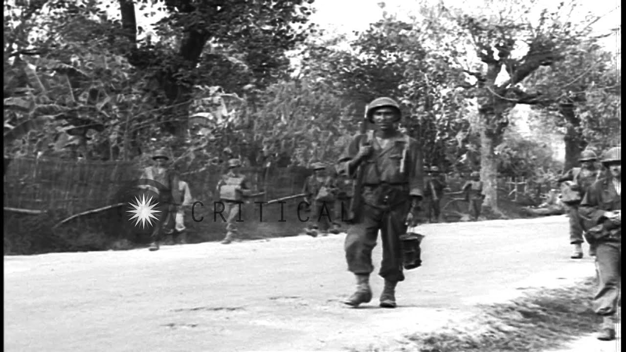 Soldiers of the 40th Division move through a village and fire heavy guns in Bamba...HD Stock Footage
