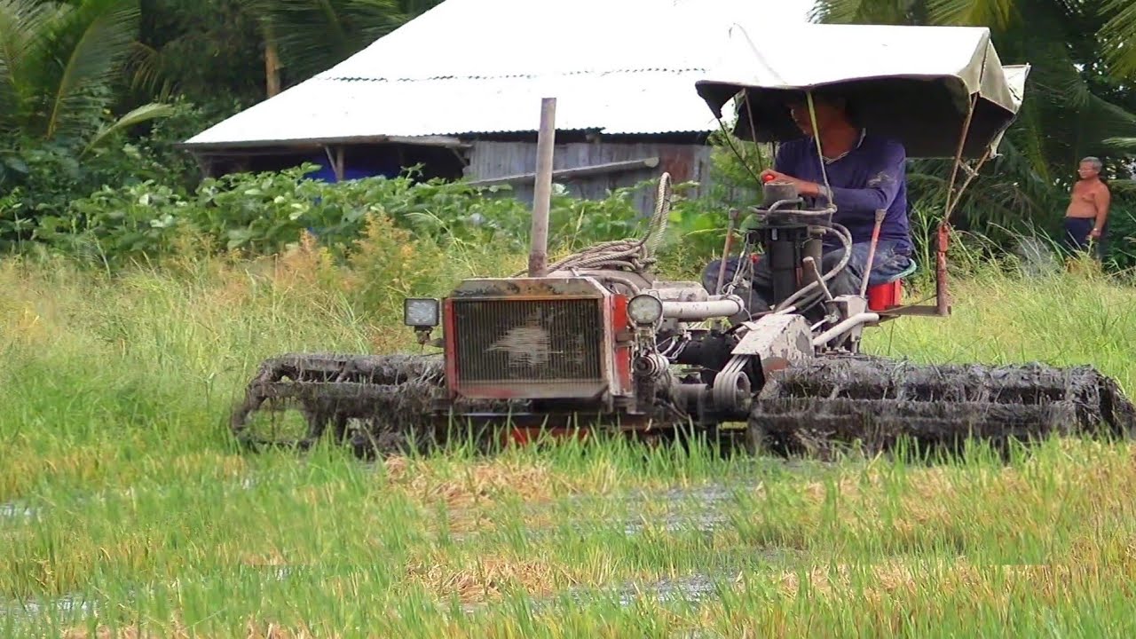 Homemade tractor shoveling wetlands