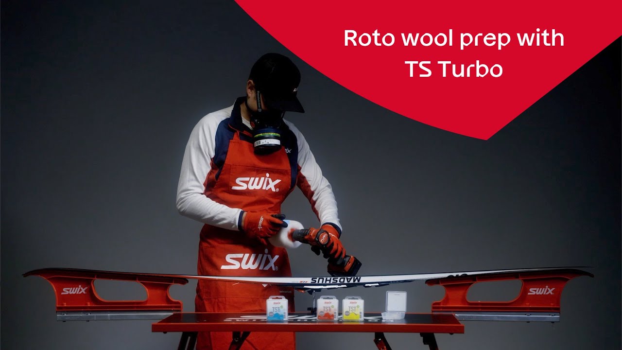 Apply glide wax on skis using roto wool
