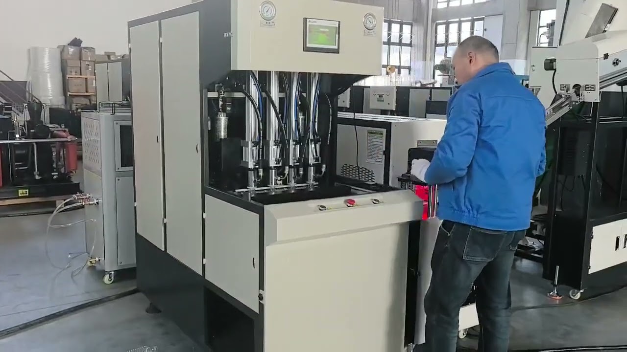 Semi automatic blow molding machine with preform loader