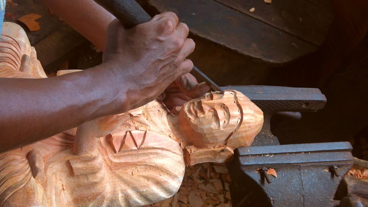 Serenity of hand carved wooden Buddha statue masterfully imposed by traditional artisan