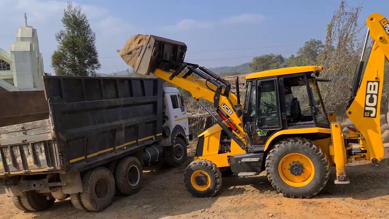 Jcb loading sand in a dump truck