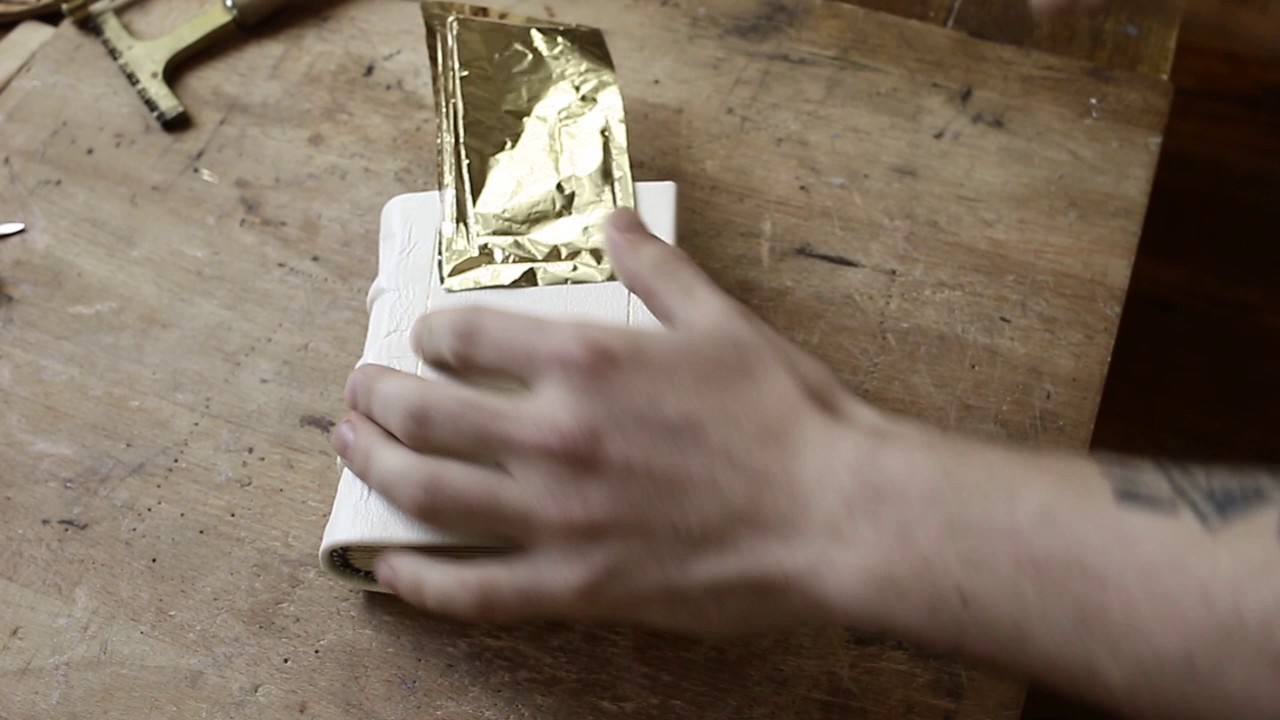 Gilding with foil on white leather