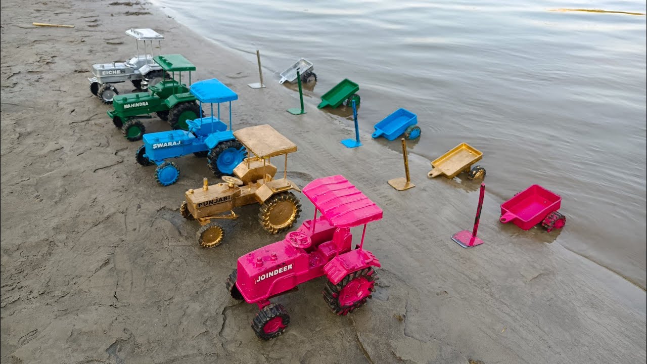 The tractor came out of the water and went near the trolley, the trolley was on the shore#292