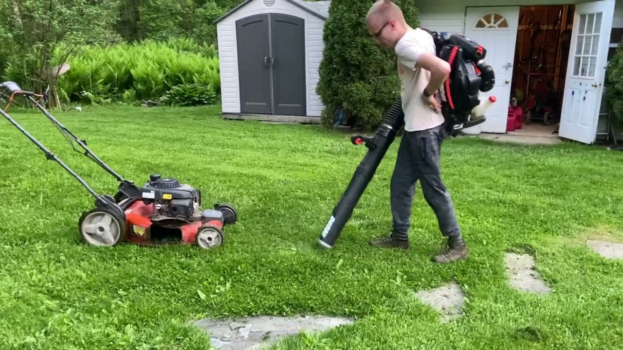 Blowing the push mower off with the leaf blower