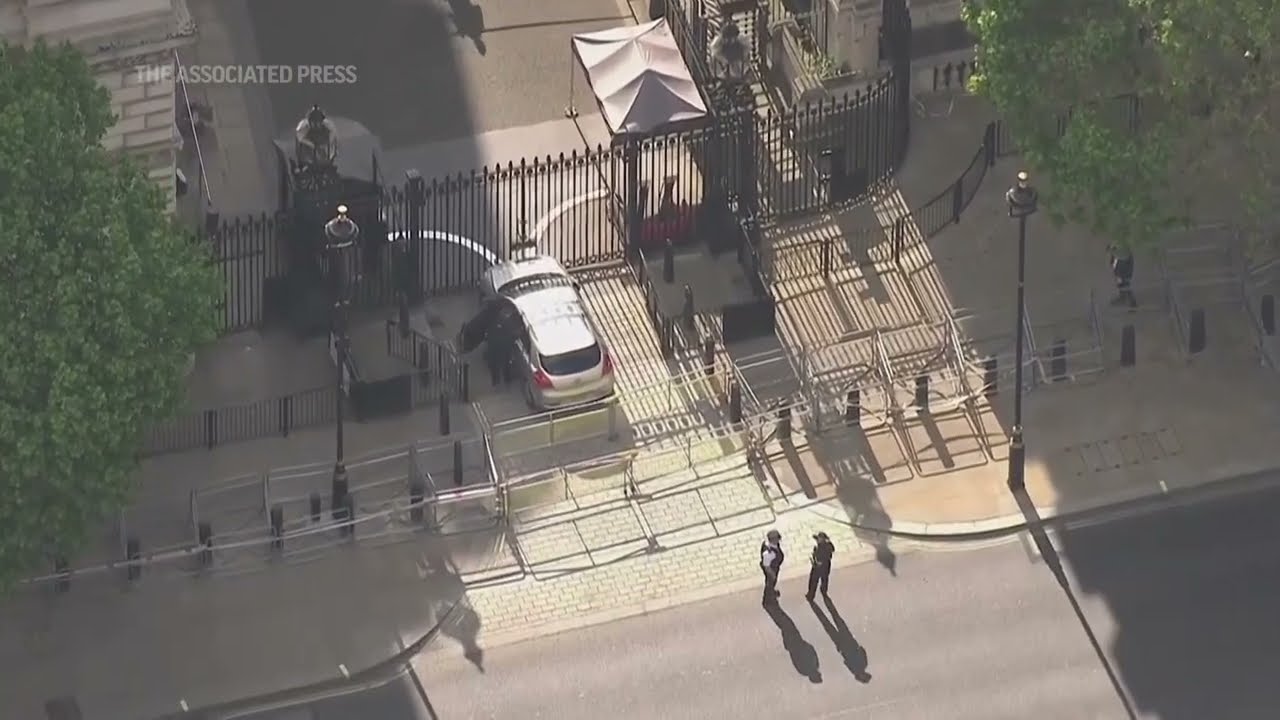 Police cordon around crashed car at Downing St. gate in London