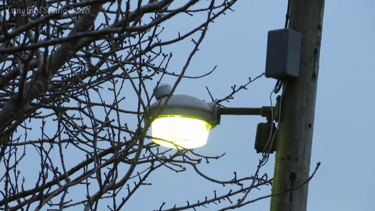 Old UK Street Light turning on (with Church Bells)
