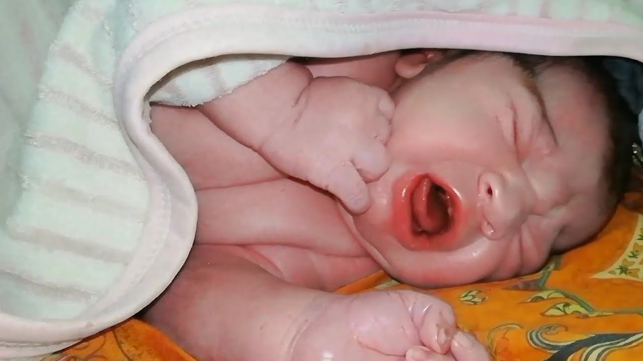 Adorable hungry newborn little princess crying for milk