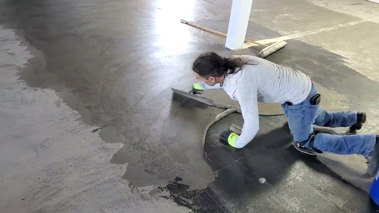 feather finishing the floor before glue down luxury vinyl plank installation.