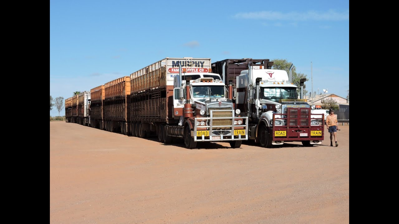 Three Massive Road Trains pulling out onto Stuart Highway Australia.