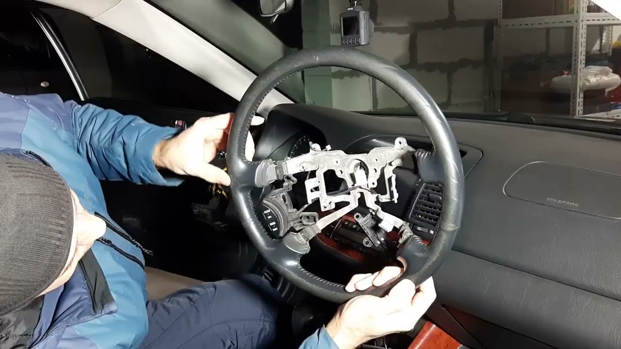 Reupholstering the steering wheel of a Toyota Camry 30 with new leather.