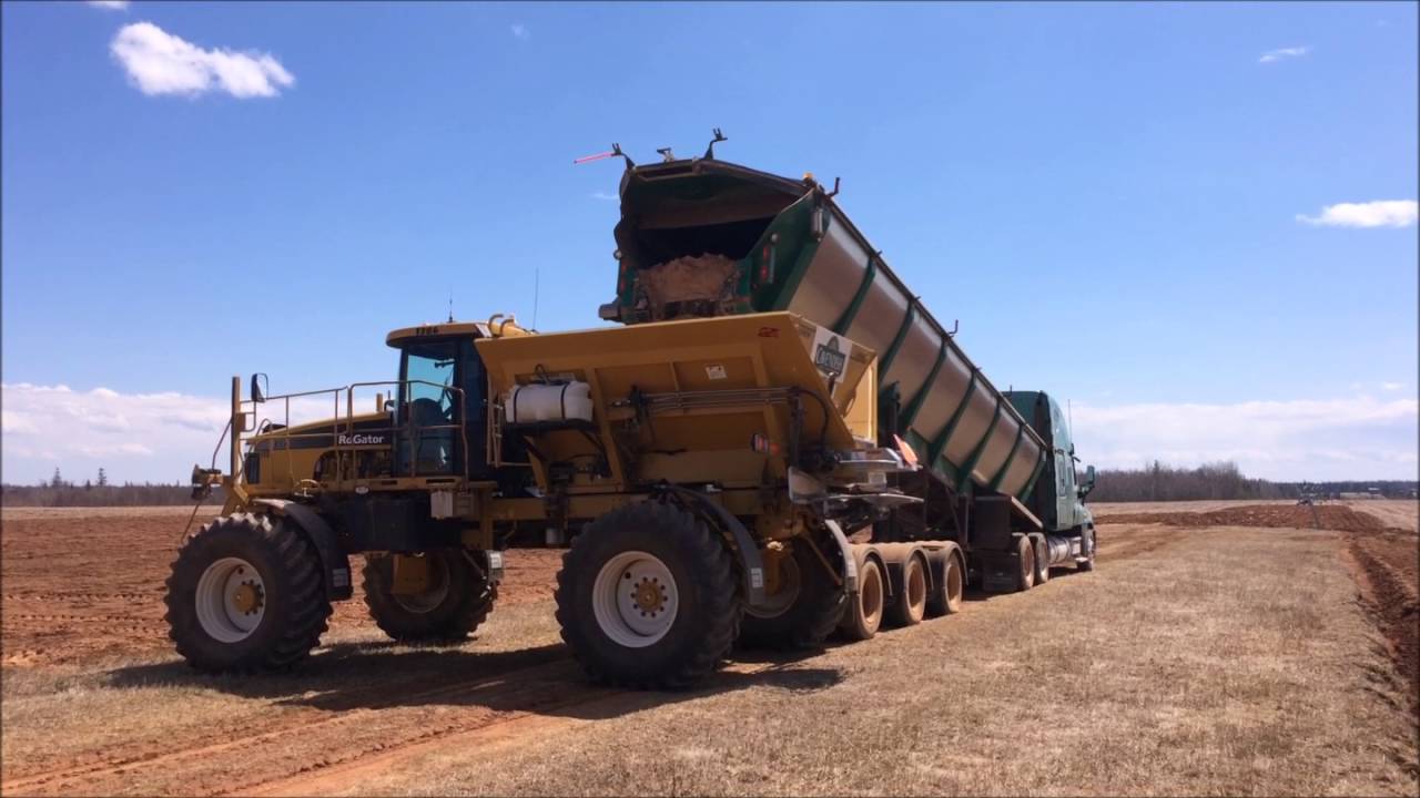Trout River Rear Lift Unloading Into Lime Spreader
