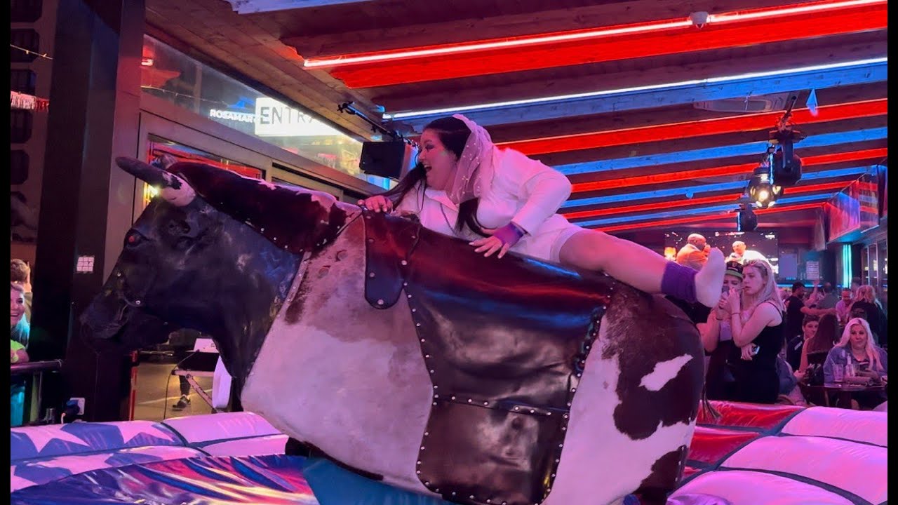 Pretty Girl in White Dress Riding on a Bull in Benidorm | Mechanical Bull Riding  in 4K