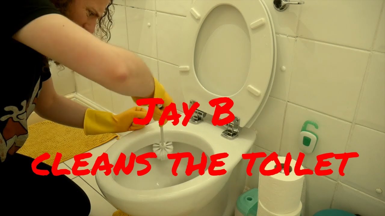 Jay B cleans the toilet