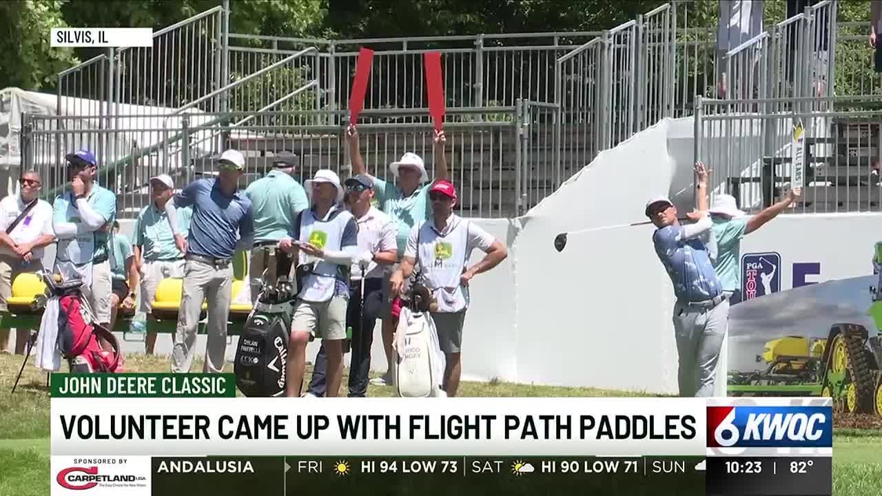 Long-time volunteer behind flight path paddles