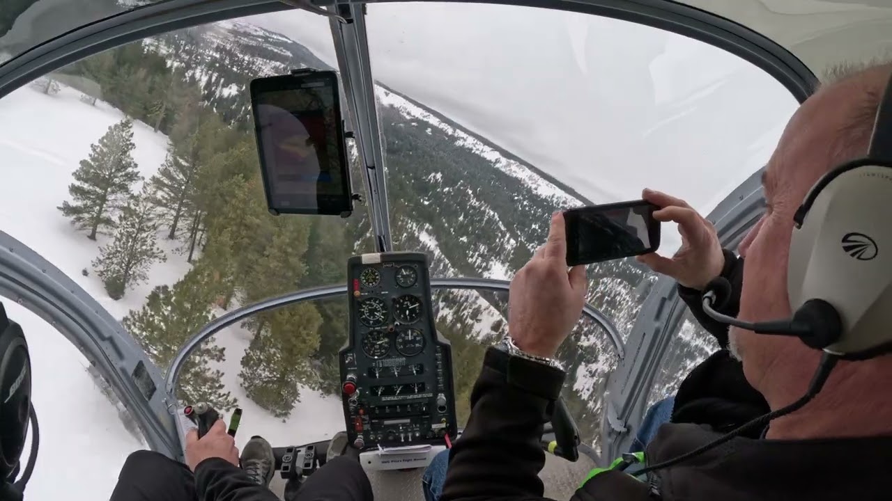 Flying feet of the ground and weaving between trees in a helicopter