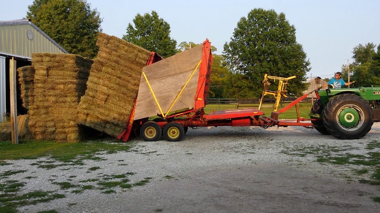 Newholland bale wagon stacking hay outside