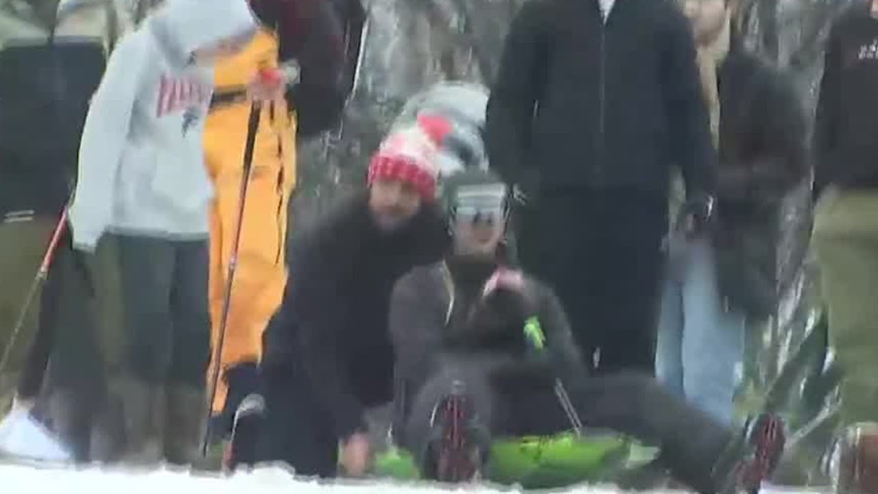Atlanta News First Reporter Patrick Pete sleds down snowy hill at Piedmont Park