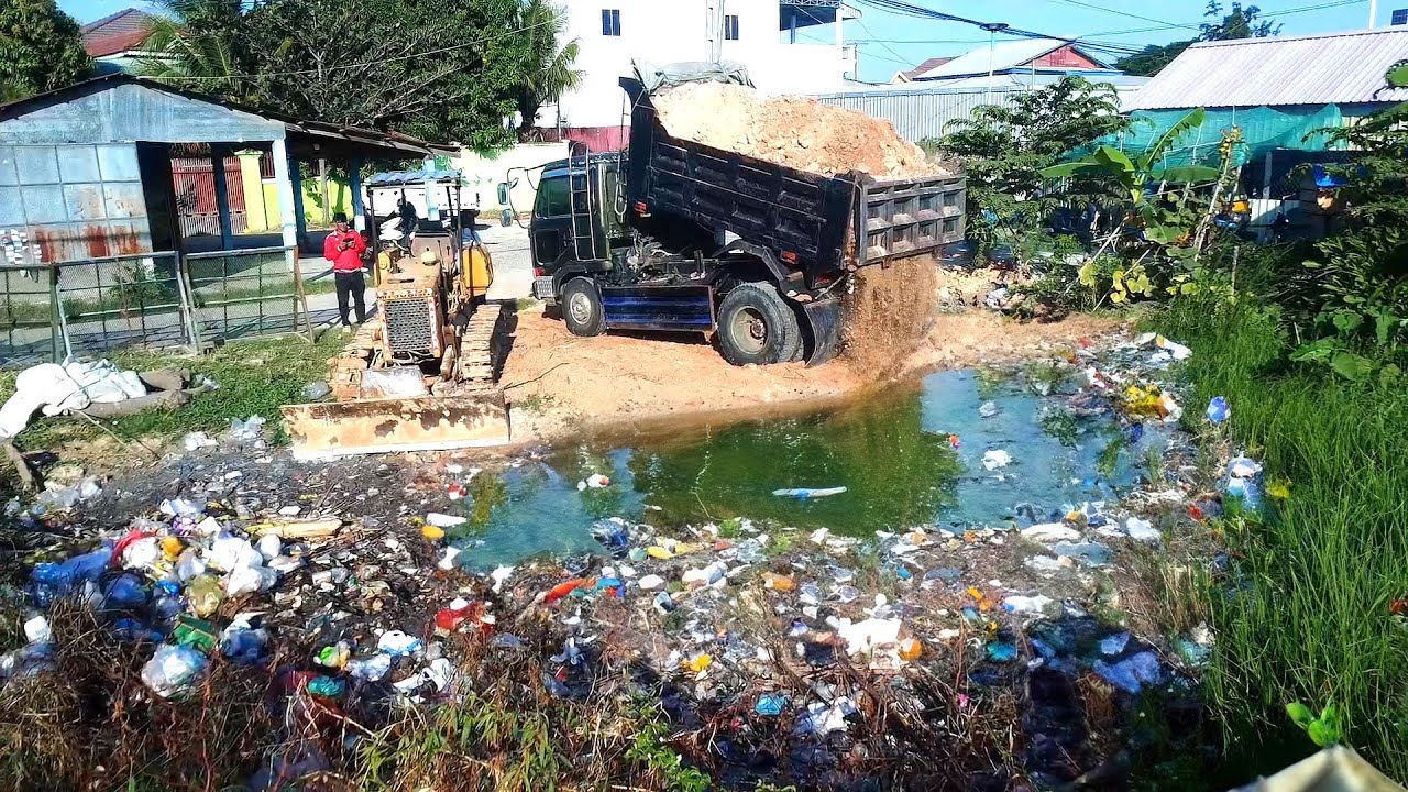 The Best Working for Bulldozer and Trucks Pushing Soil to the many Garbage and Flood Forest