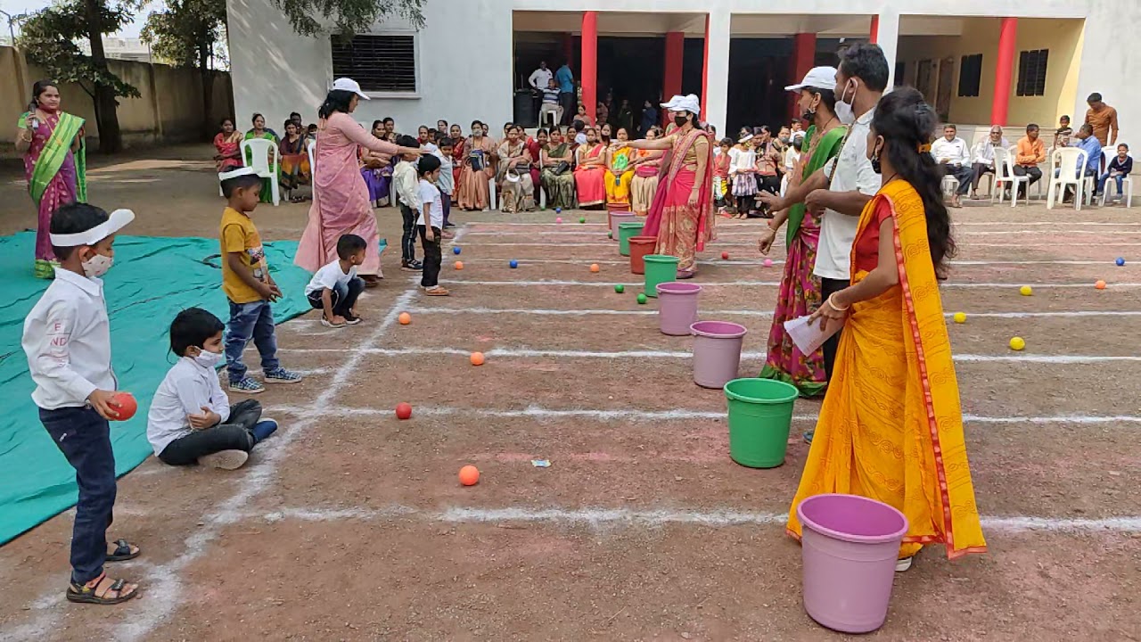 BCS Throwing balls in to bucket game for UKG students