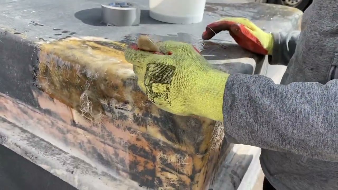 Repairing a water tank using a fibreglass repair kit
