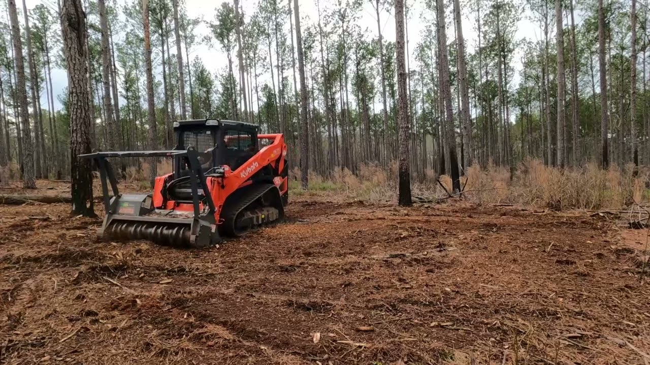Kubota SVL 75-3 tackling a stump field and wood debris.  Machine sound with no music or talking.