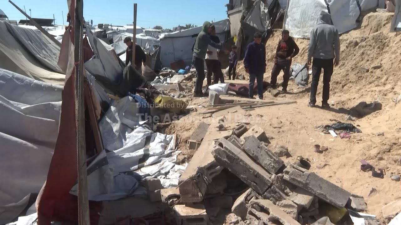 Distraught relatives mourn women and child killed in collapse of wall on tents for displaced