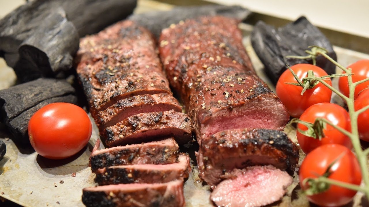 Caveman grilling lamb backstrap - by HanksTrueBBQ.com