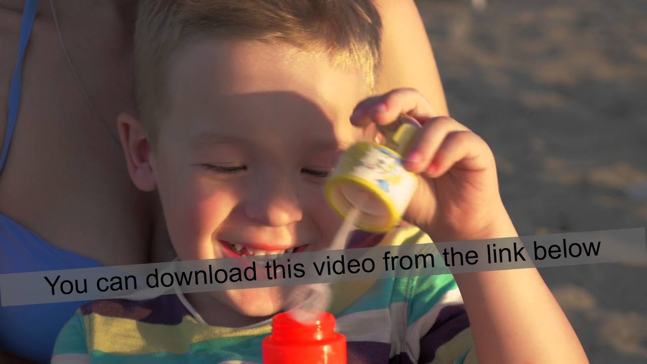 Little happy child blowing bubbles outdoor