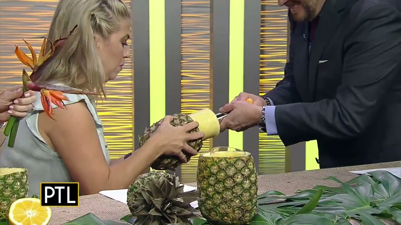 How to make a tropical floral centerpiece with fresh oranges and a pineapple vase.