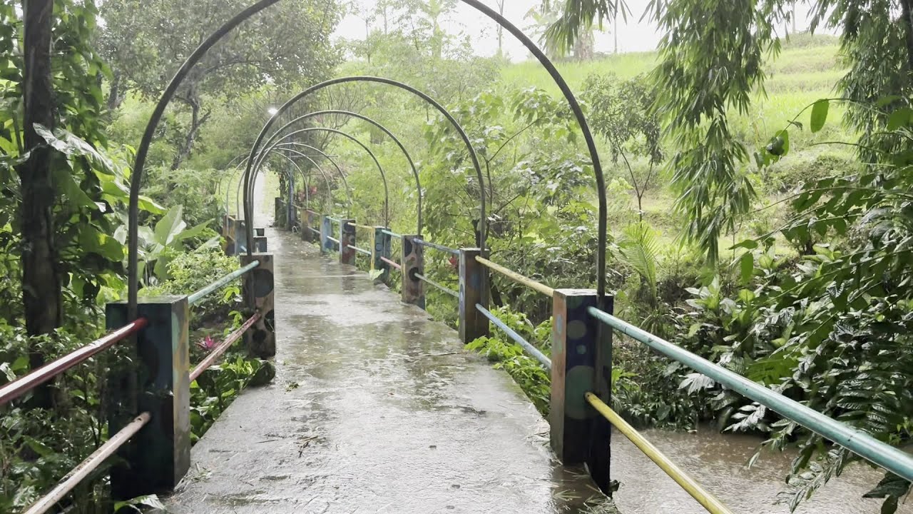 Walking in heavy rain in a beautiful village