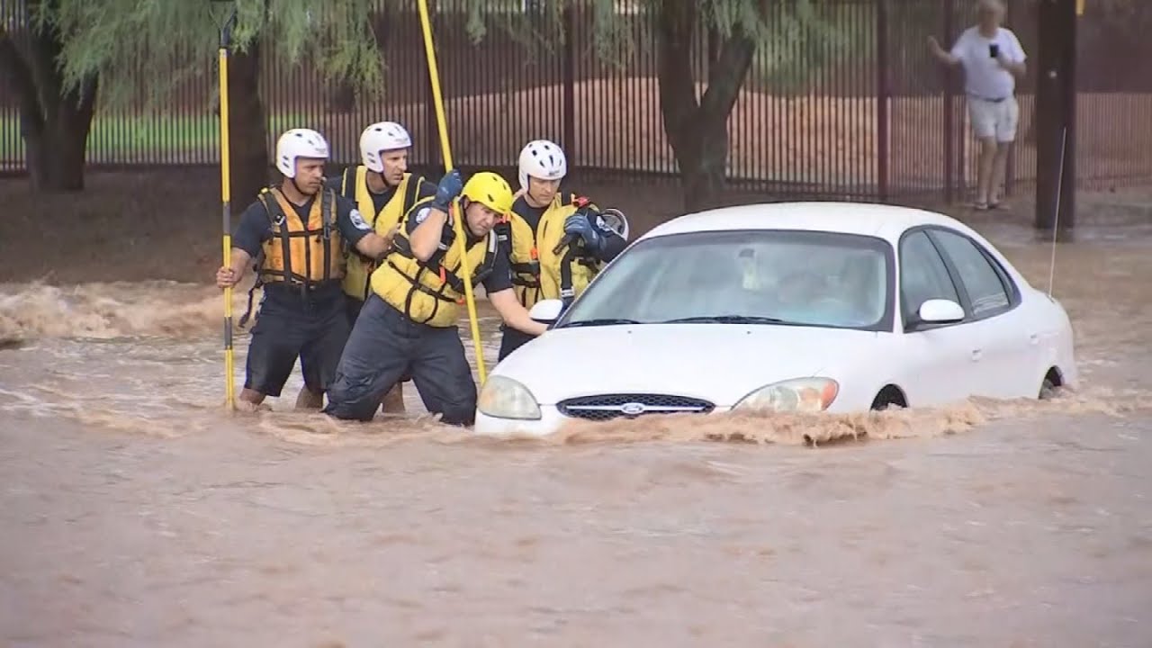 Car gets trapped on flooded road; driver rescued