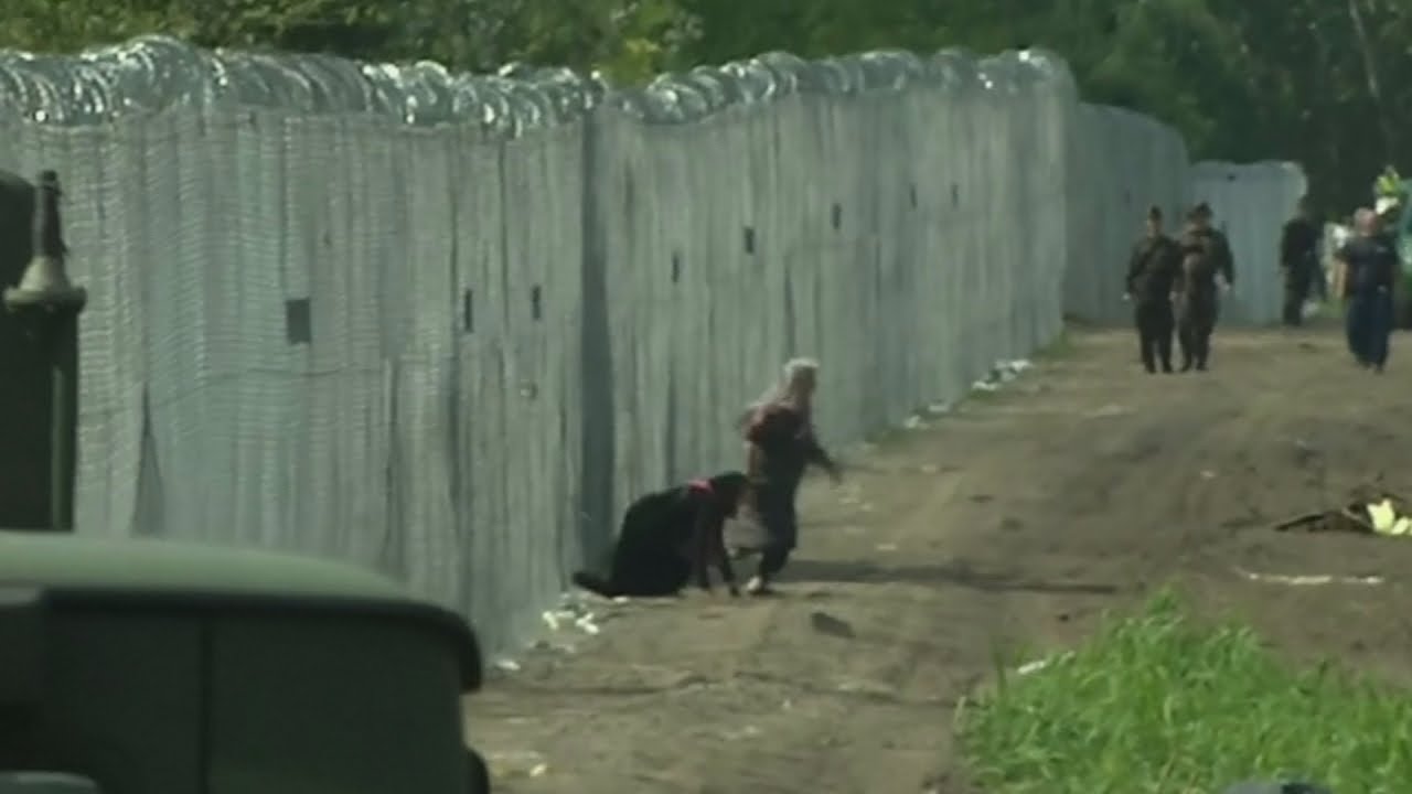 Refugees break through newly-built border fence in Hungary