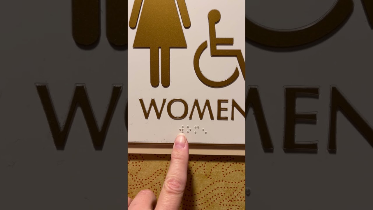 How to read the braille on the women&rsquo;s restroom sign.