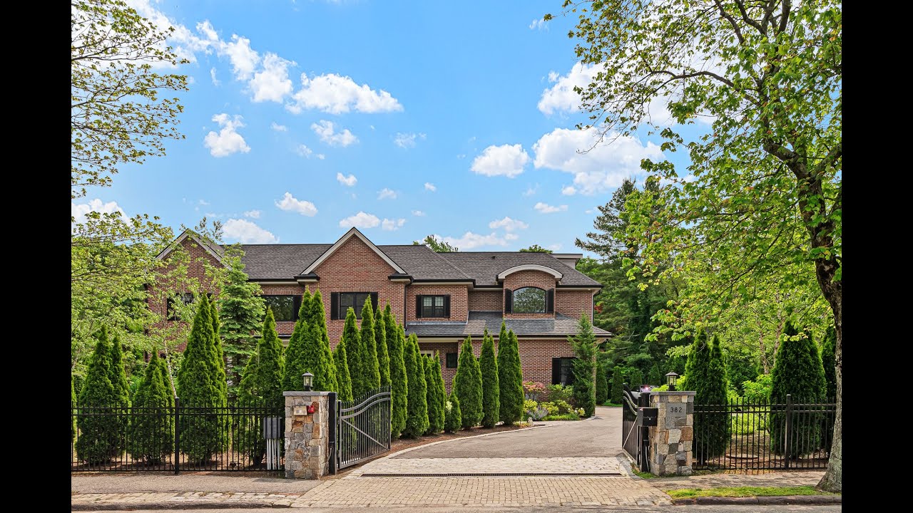 Enter the gates into this stunning Colonial-style home in Brookline