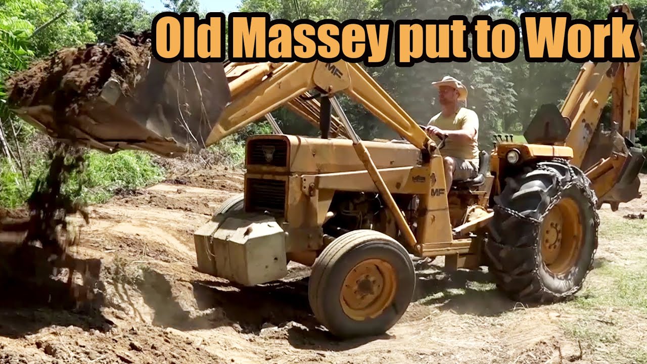 Backyard Overhaul with old MF-40 Backhoe - Grading, removing trees, and building a berm